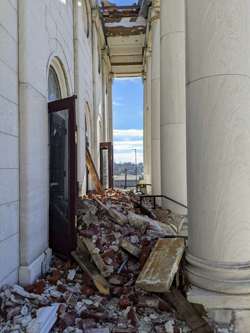 a building that has a bunch of rubble on the ground