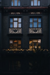 a black building with windows and a balcony