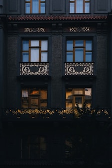 a black building with windows and a balcony