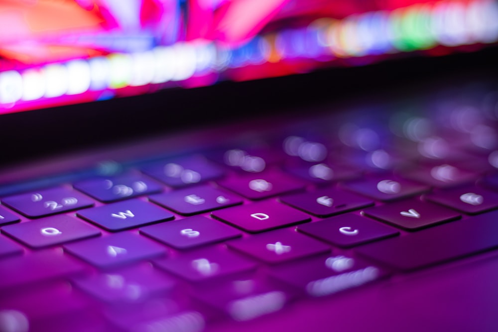 a close up of a purple keyboard on a laptop