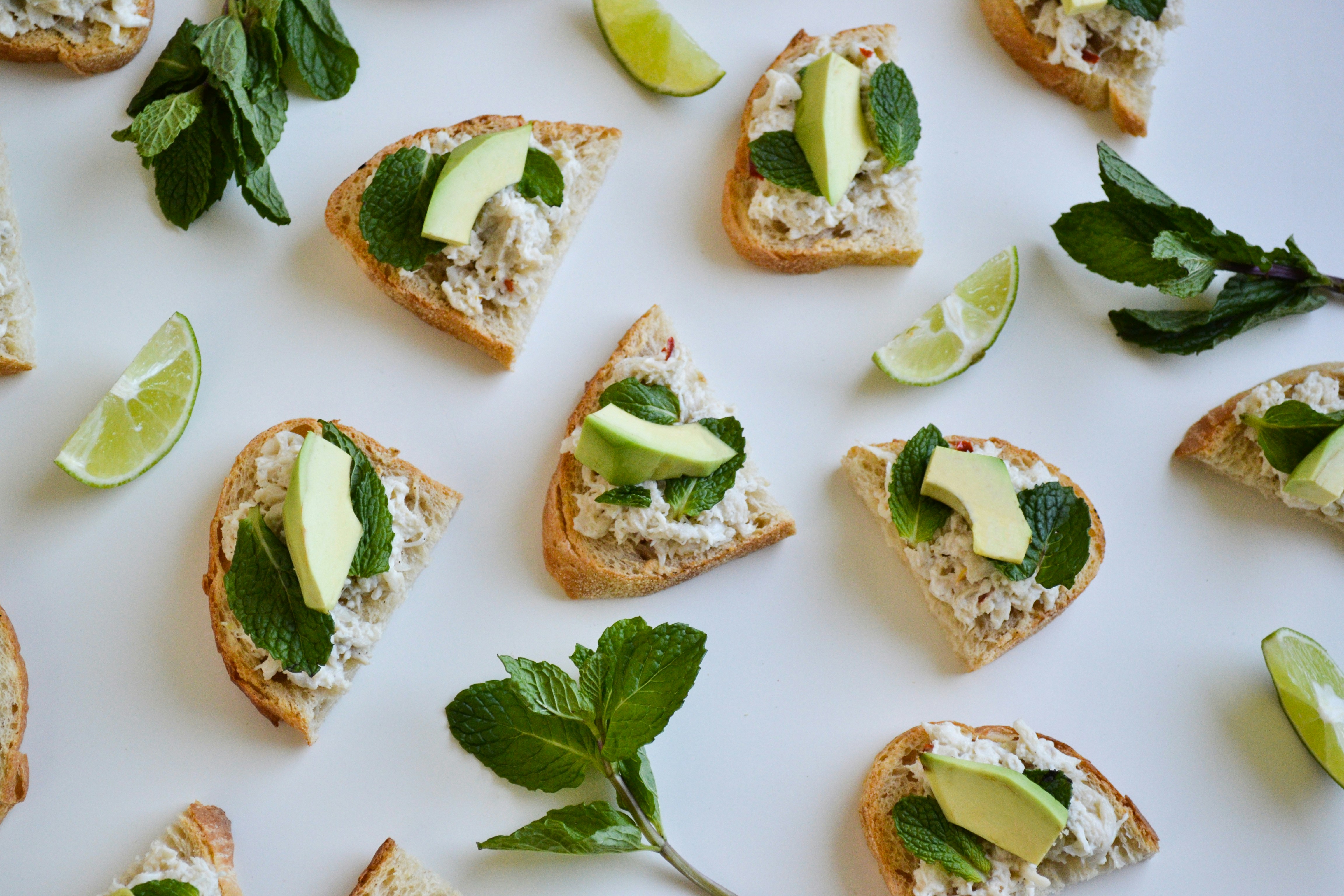 a table topped with slices of bread covered in toppings