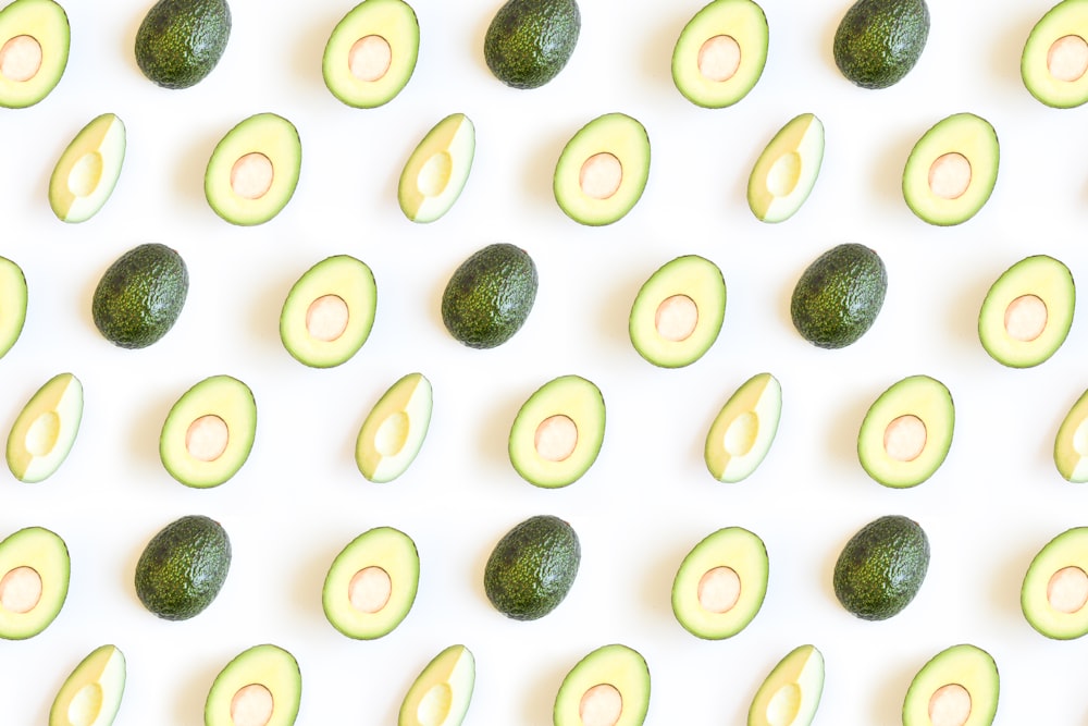 a group of avocados sitting on top of a white surface