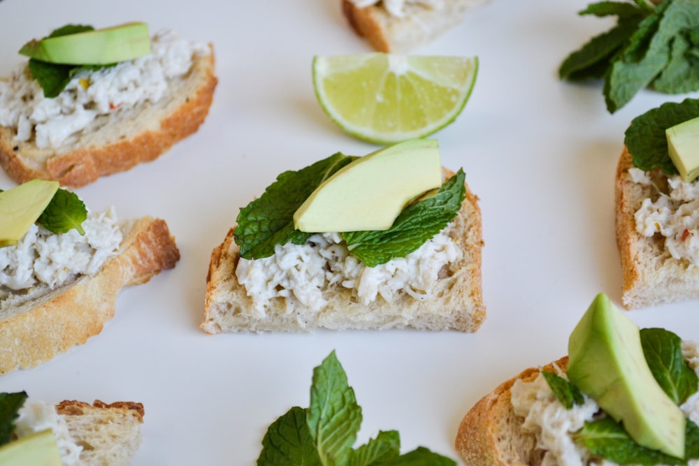 a white plate topped with slices of bread covered in toppings