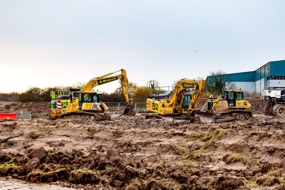 a group of construction equipment sitting in the dirt