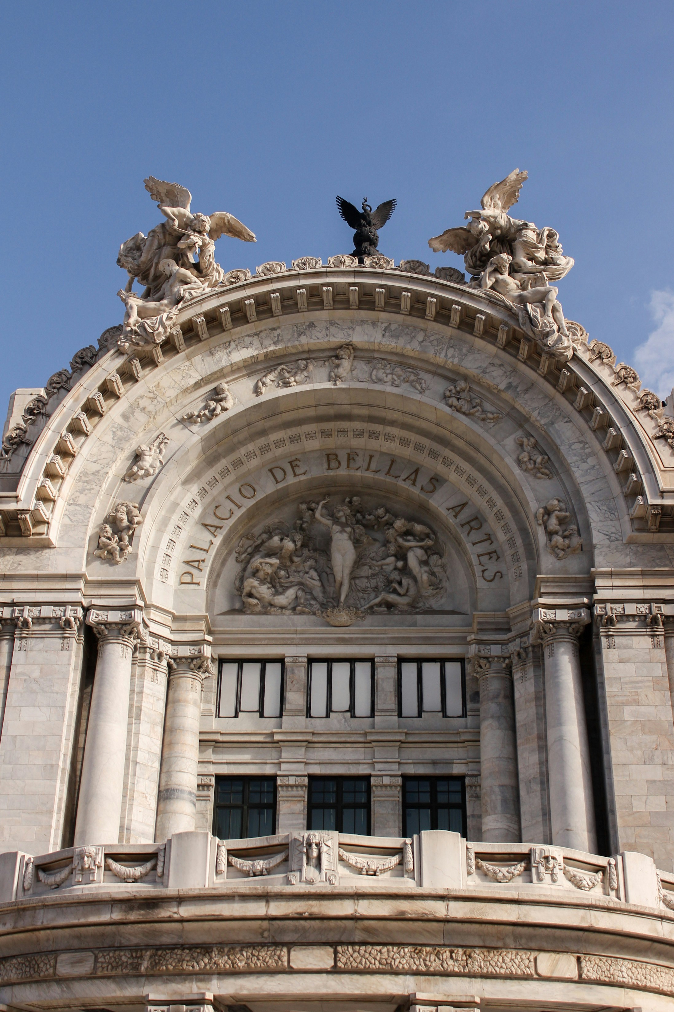 a large building with statues on top of it