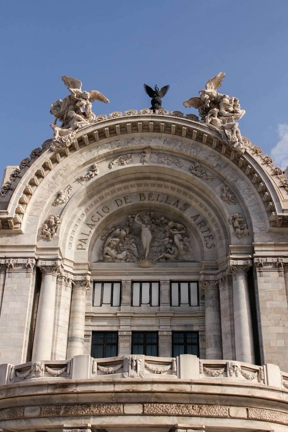 a large building with statues on top of it