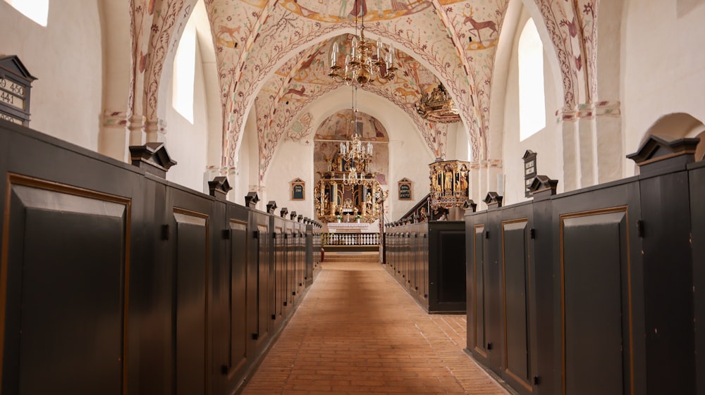 a row of black stalls in a church