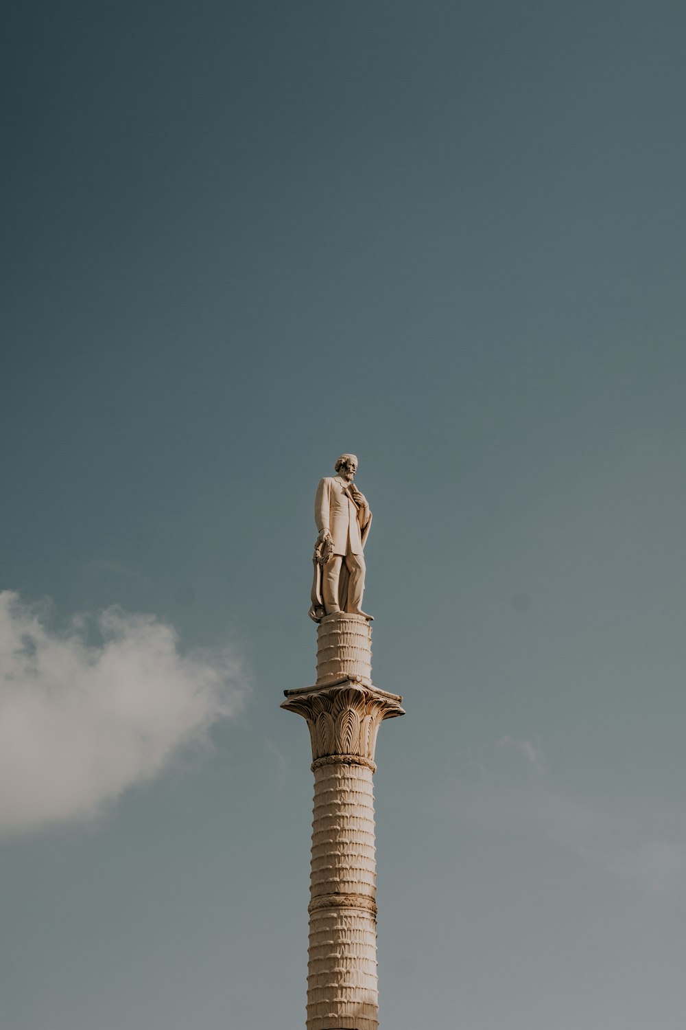 a statue of a man standing on top of a tower
