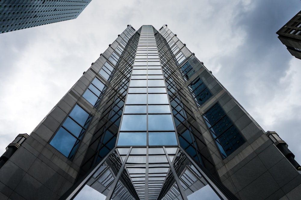 looking up at a tall building with many windows