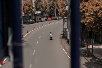 a man riding a motorcycle down a curvy street