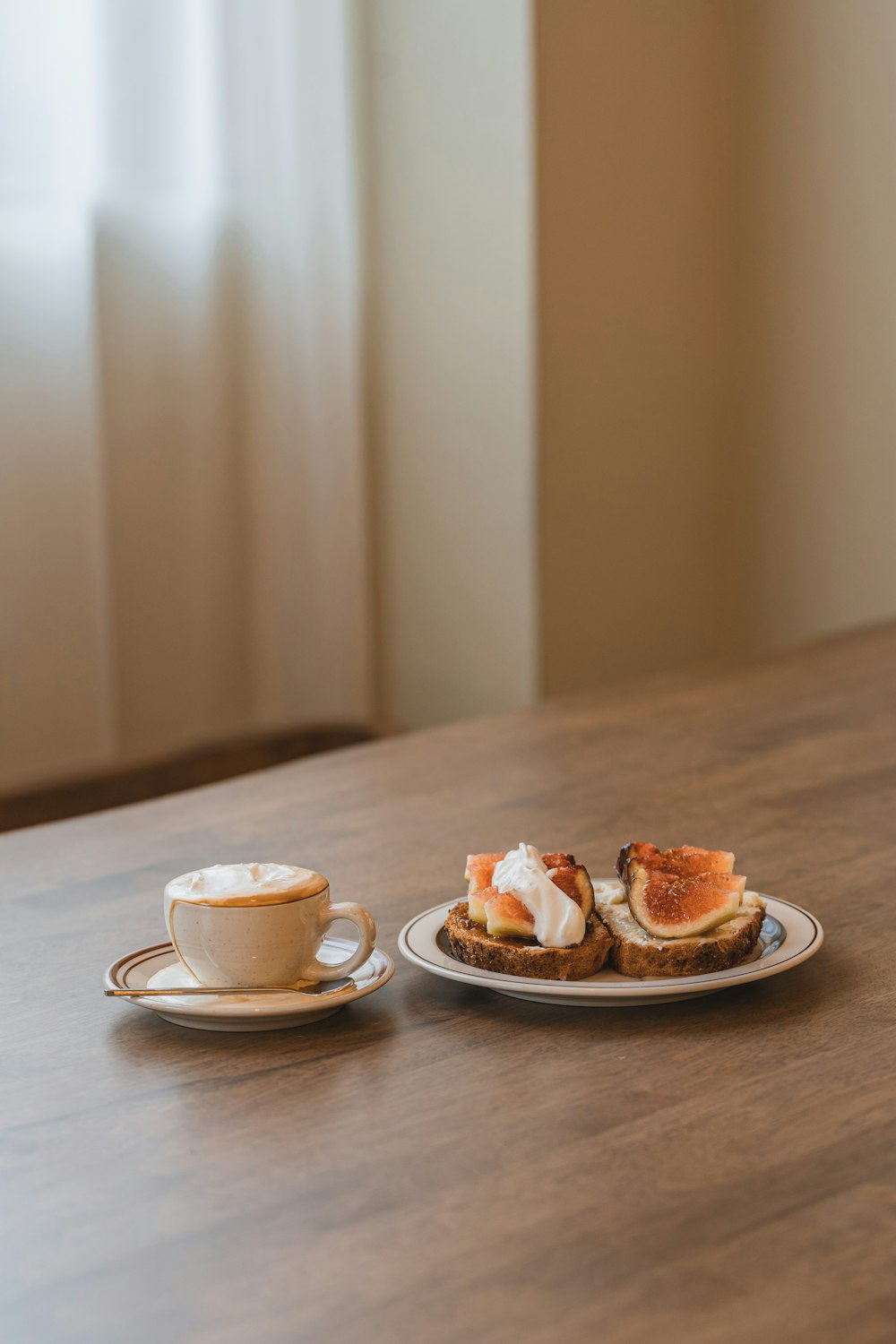 a plate of food and a cup of coffee on a table