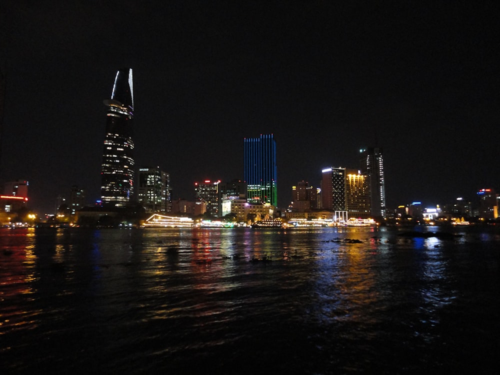 a city skyline is lit up at night