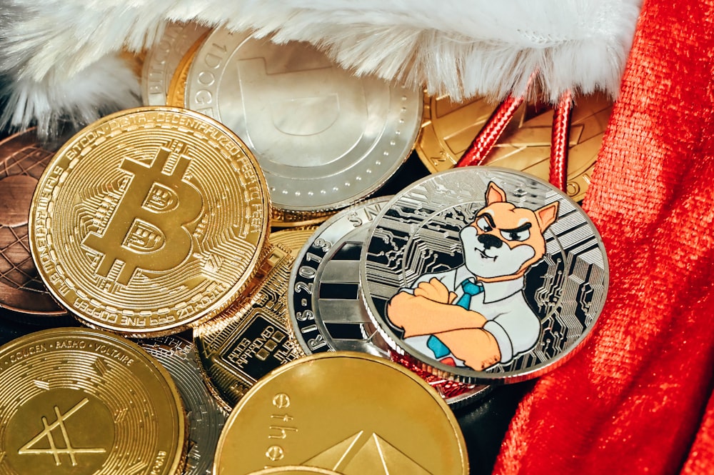 a pile of bitcoins sitting on top of a red blanket