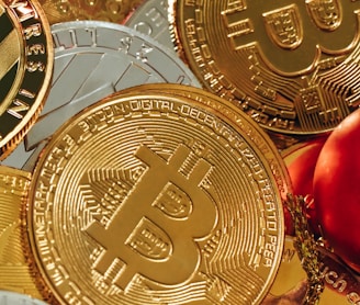 a pile of gold bitcoins next to a glass of wine