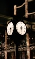 a clock on a pole in front of a building
