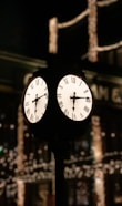 a clock on a pole in front of a building