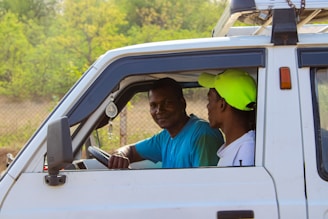 A friendly insurance agent discussing car insurance options with a client.
