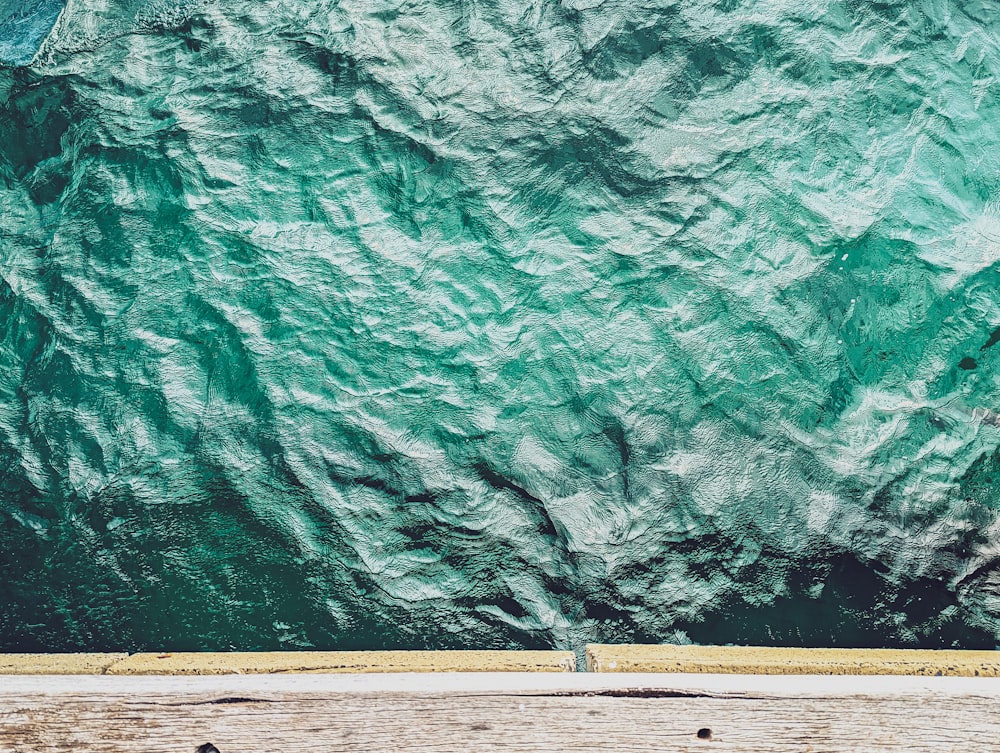 a person sitting on a bench in front of a body of water