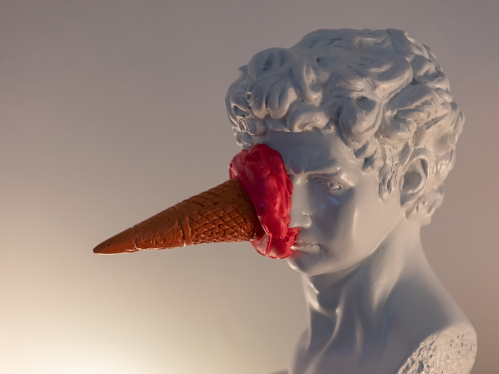 Una estatua de una mujer con un cono de helado en la cabeza