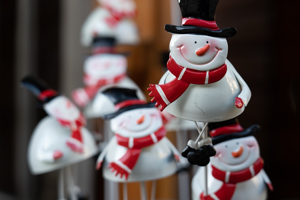 a group of snowmen with hats and scarfs