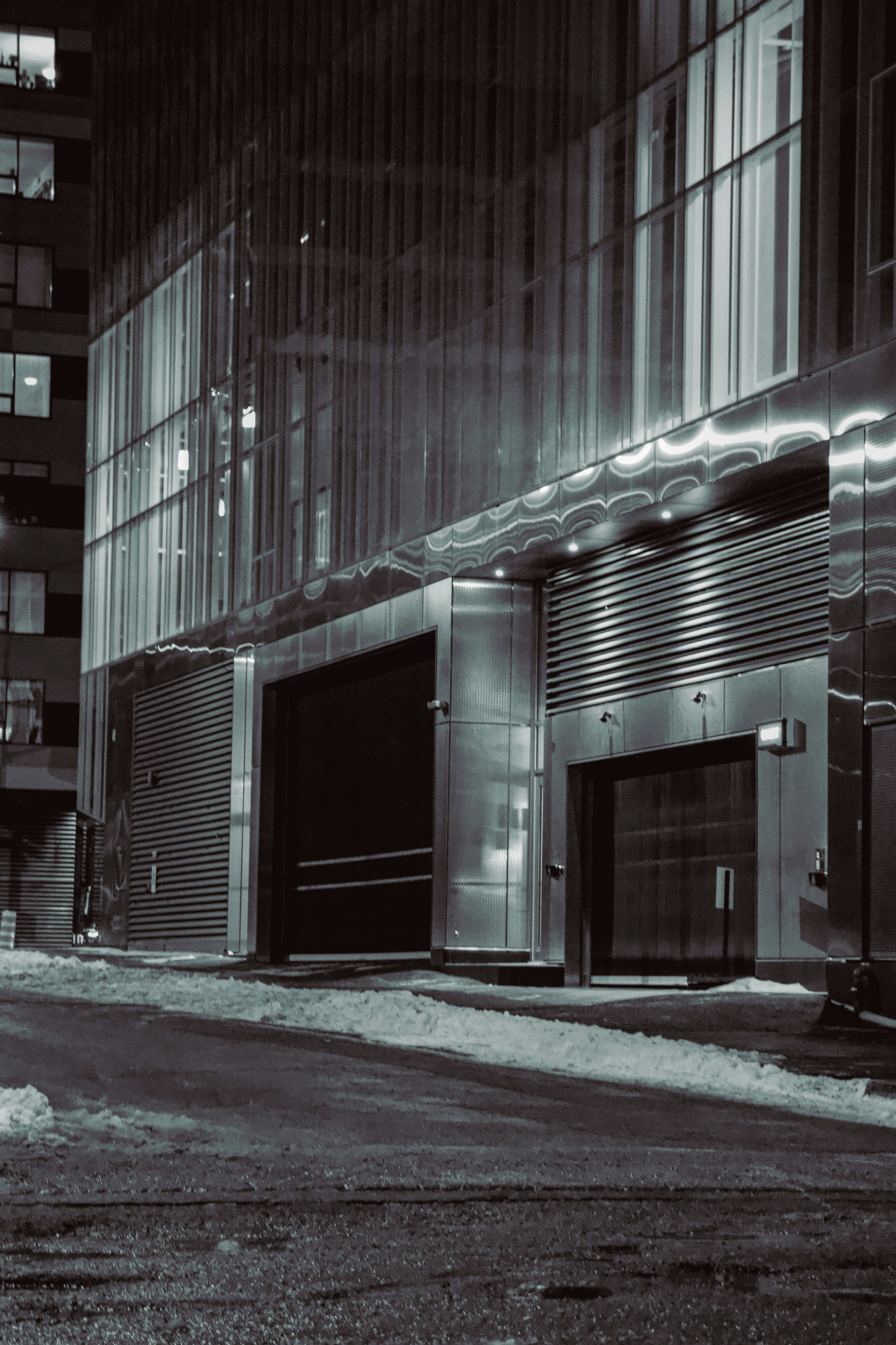 a black and white photo of a building at night