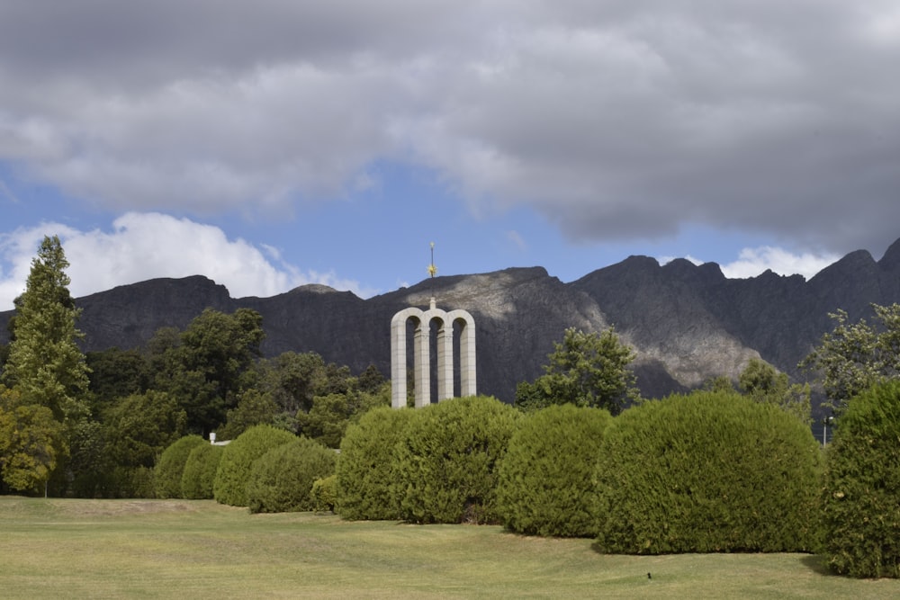 a church tower surrounded by trees and mountains