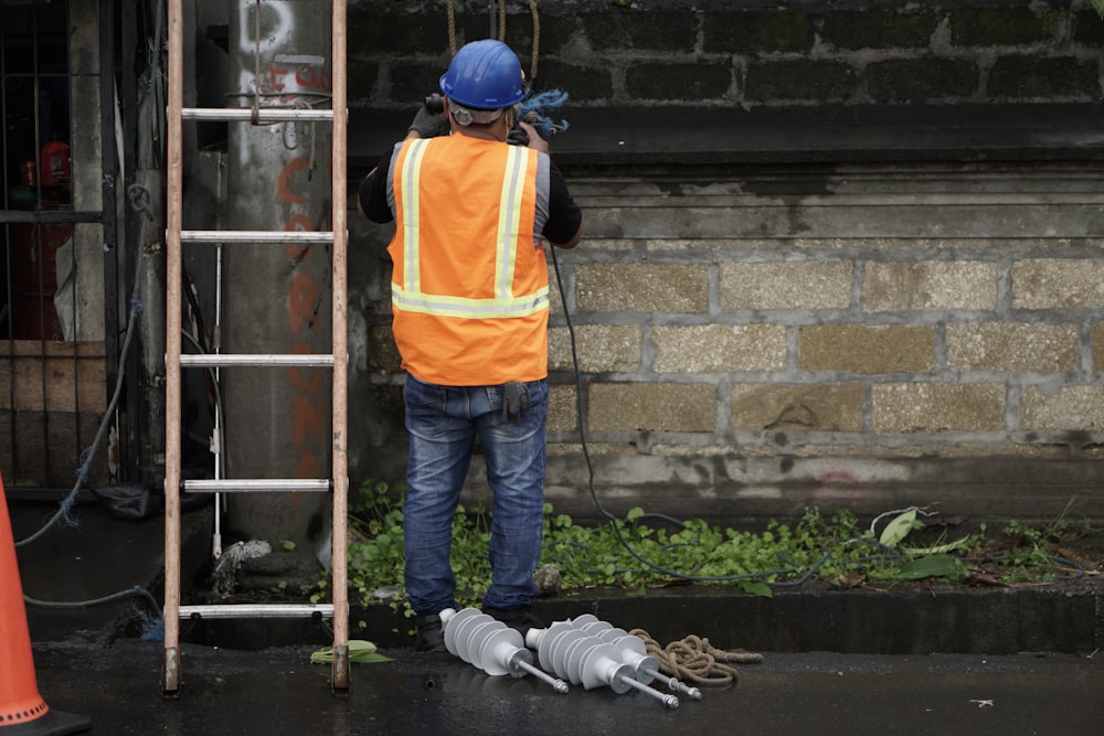 a construction worker standing next to a ladder