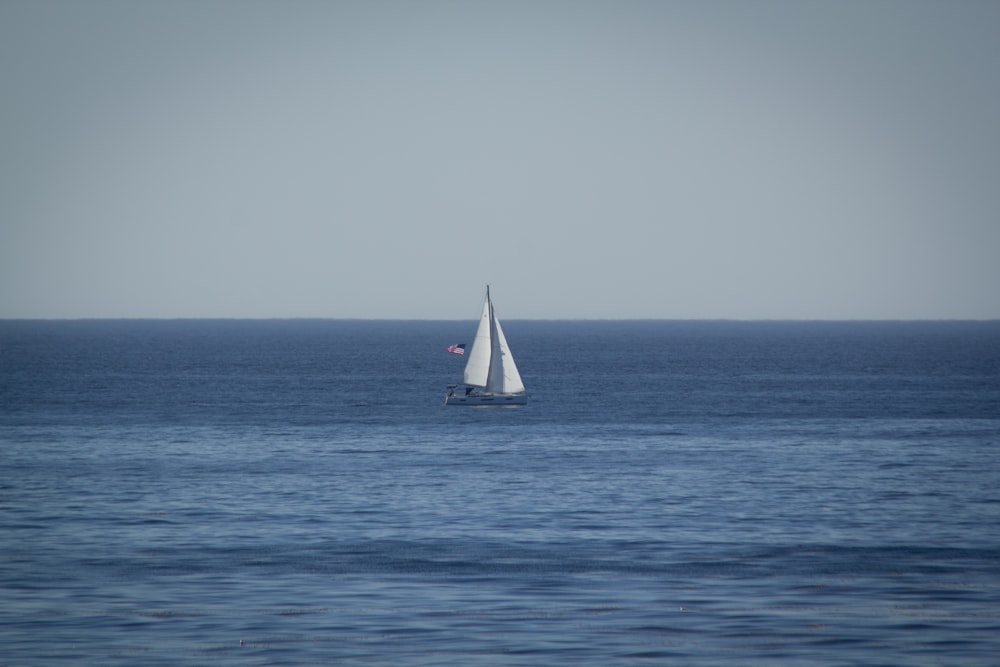 a sailboat in the middle of the ocean