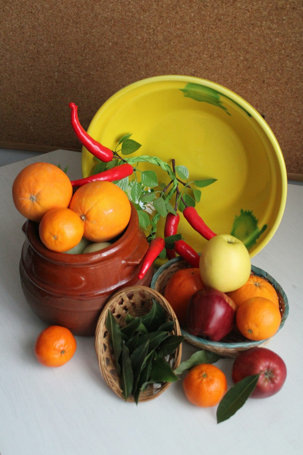 a yellow bowl filled with oranges and other fruit