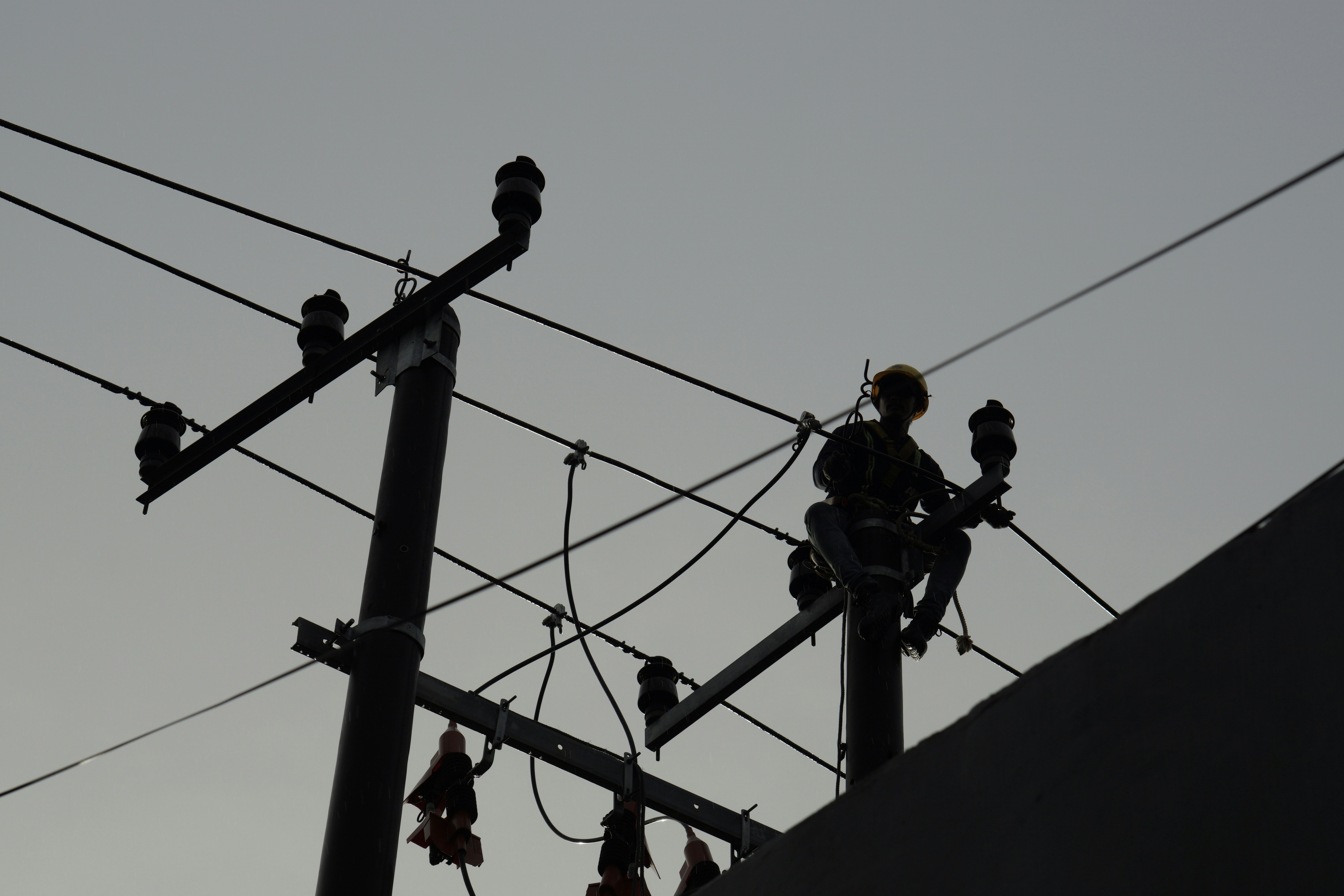 a person is sitting on a power line