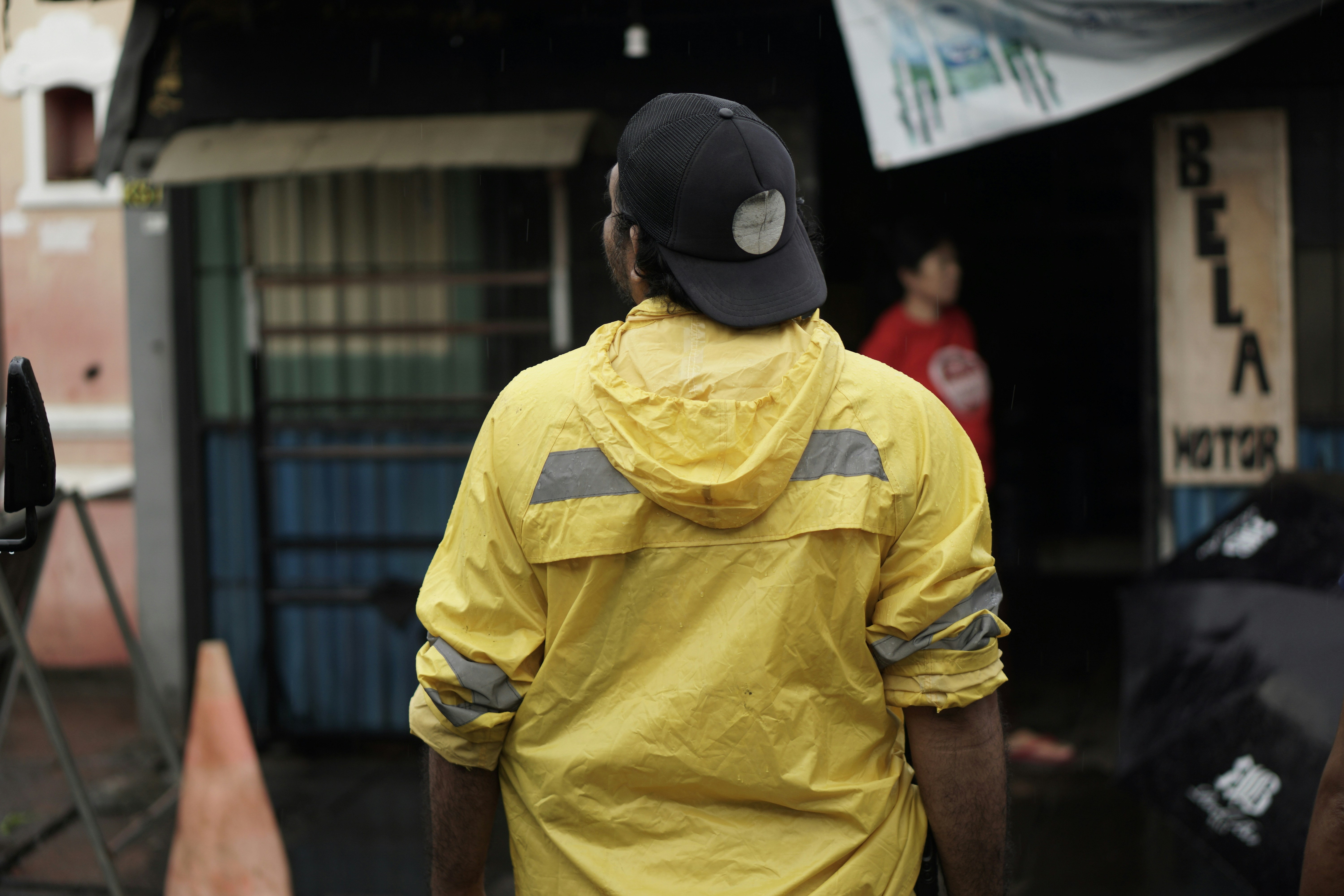 a man in a yellow jacket and a black hat