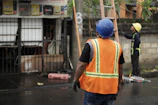 a man in an orange safety vest and a man in a blue helmet
