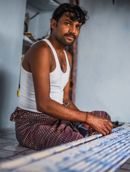 a man sitting on the floor in a room