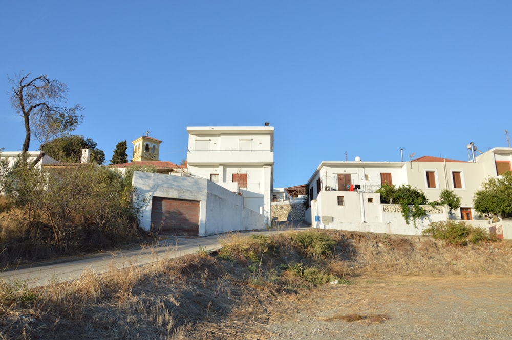 a dirt road in front of a row of houses