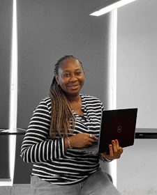 Customer smiling while completing an online flight refund on a laptop.