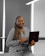 Smiling customer using a laptop while enjoying high-speed internet at home.