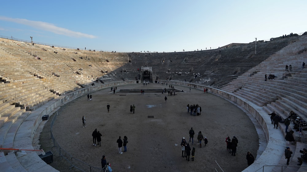 a group of people standing around an empty stadium