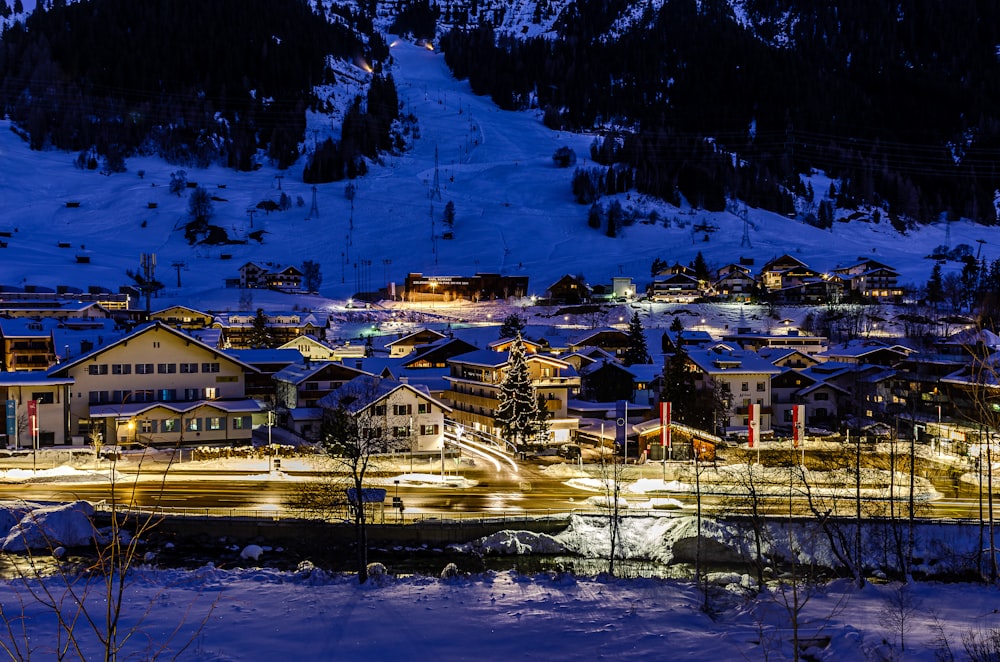 a town is lit up at night in the mountains
