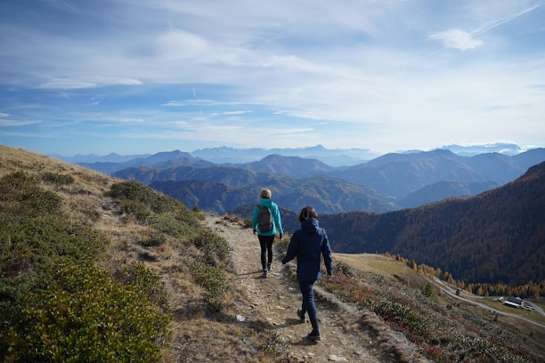 a couple of people that are walking down a hill