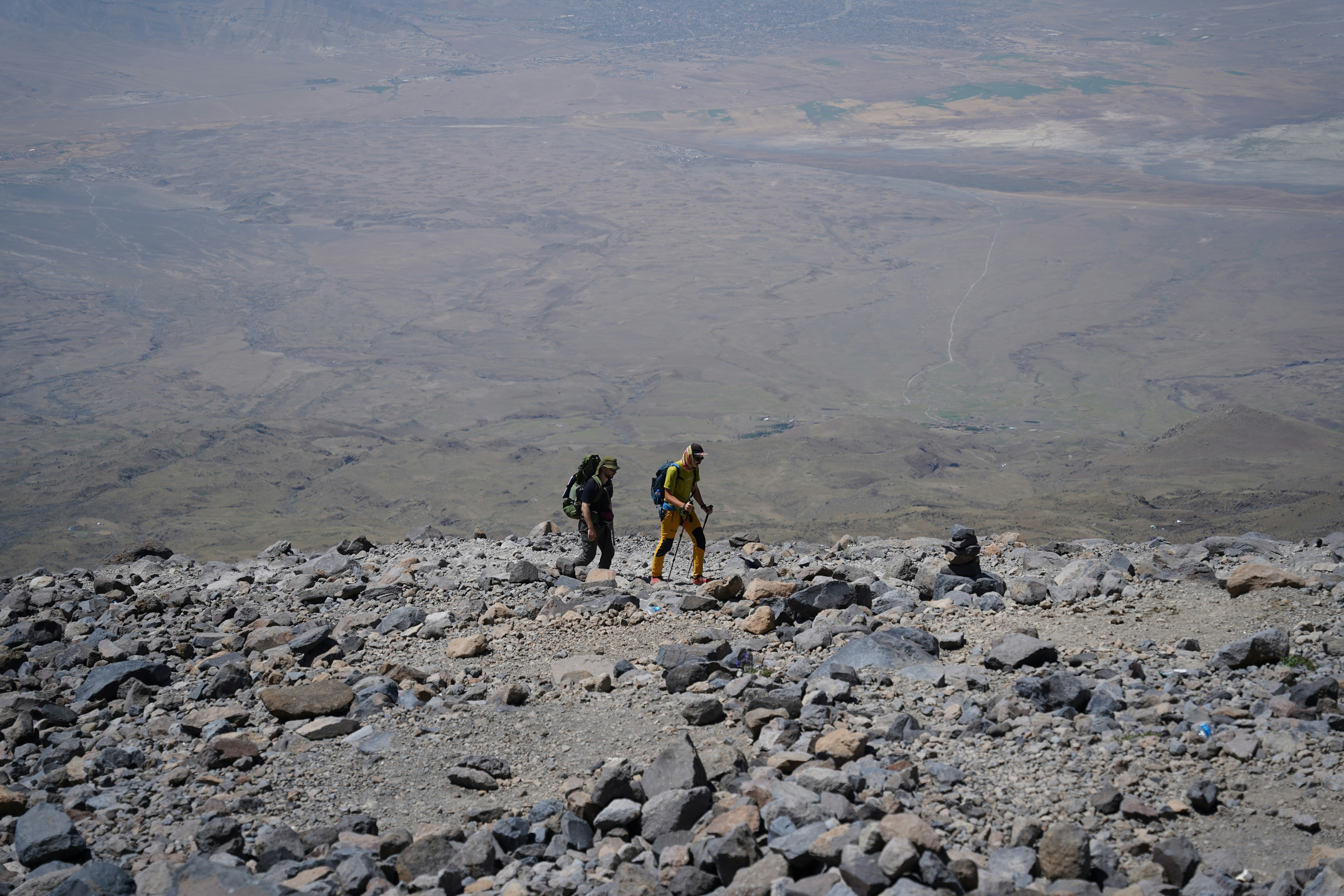 a group of people hiking up a rocky hill