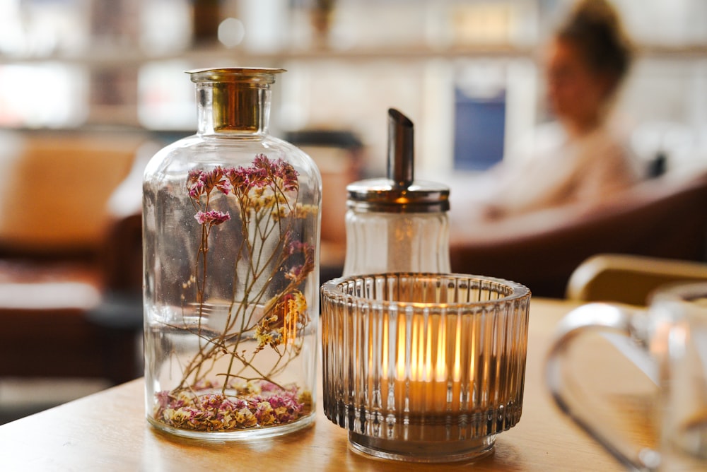 a glass vase with flowers inside of it on a table