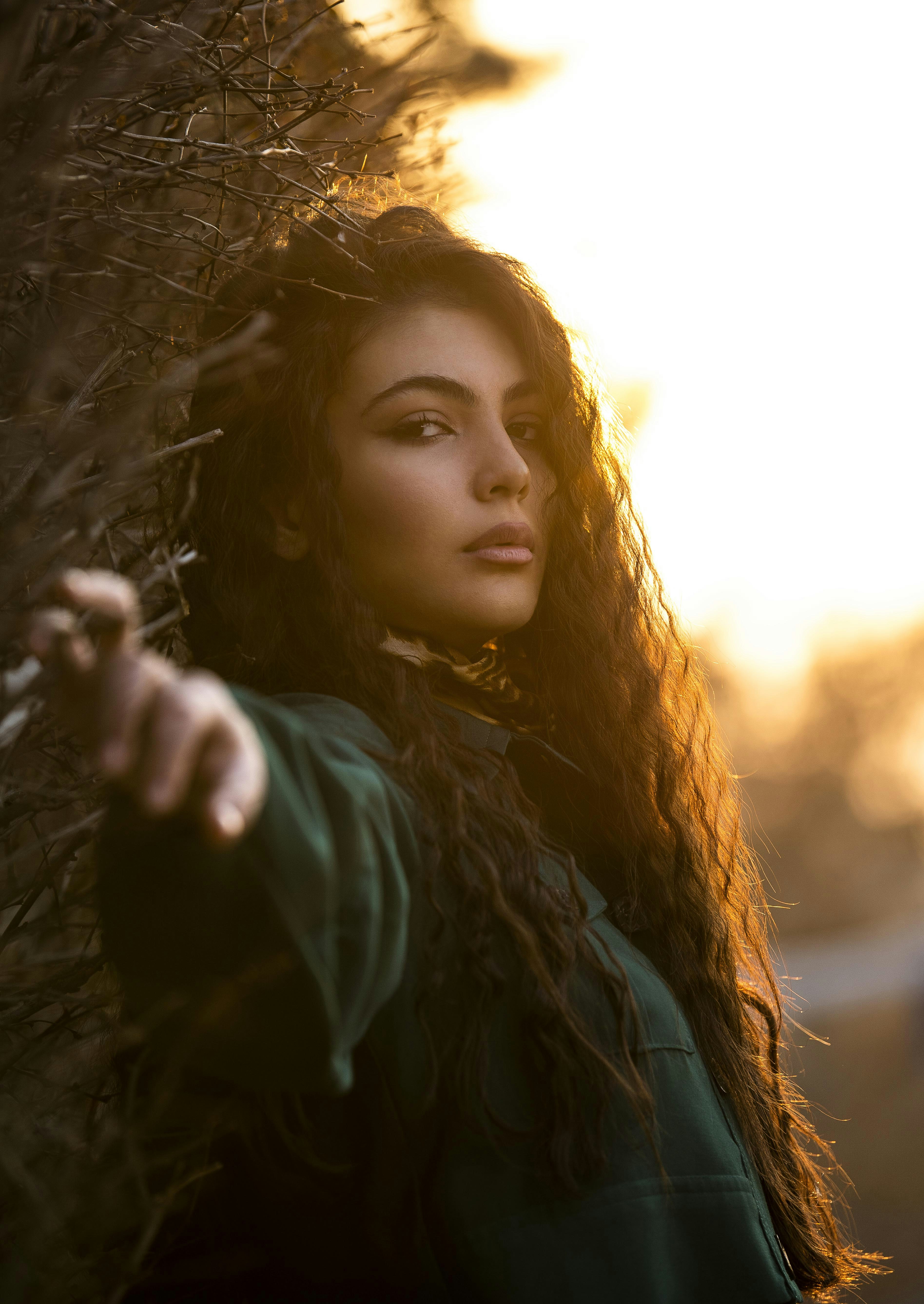 A woman with long hair standing in front of a tree photo – Free Fashion ...
