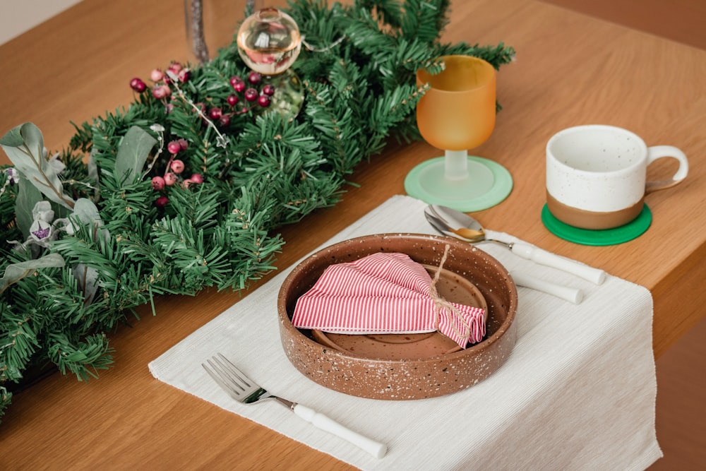 a table topped with a bowl of food and a cup of coffee