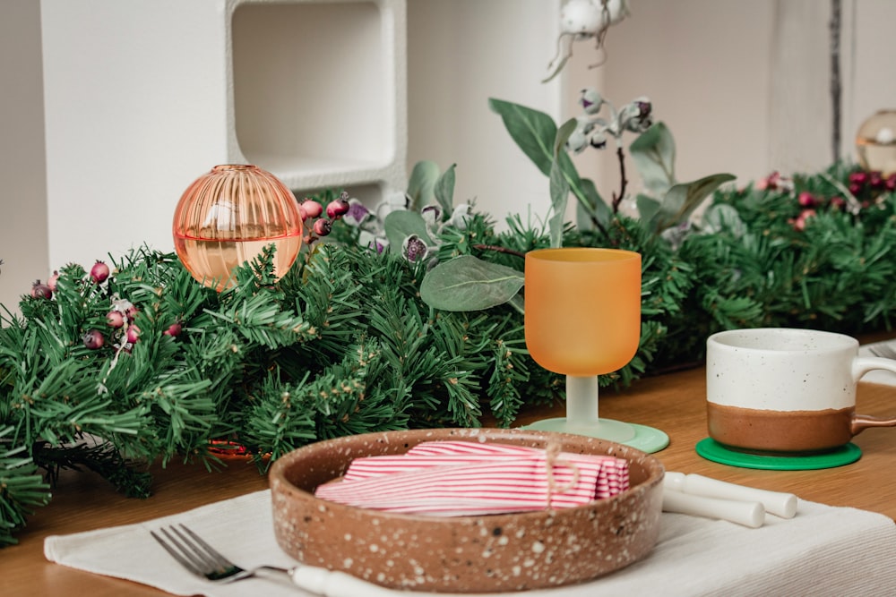 a wooden table topped with plates and cups