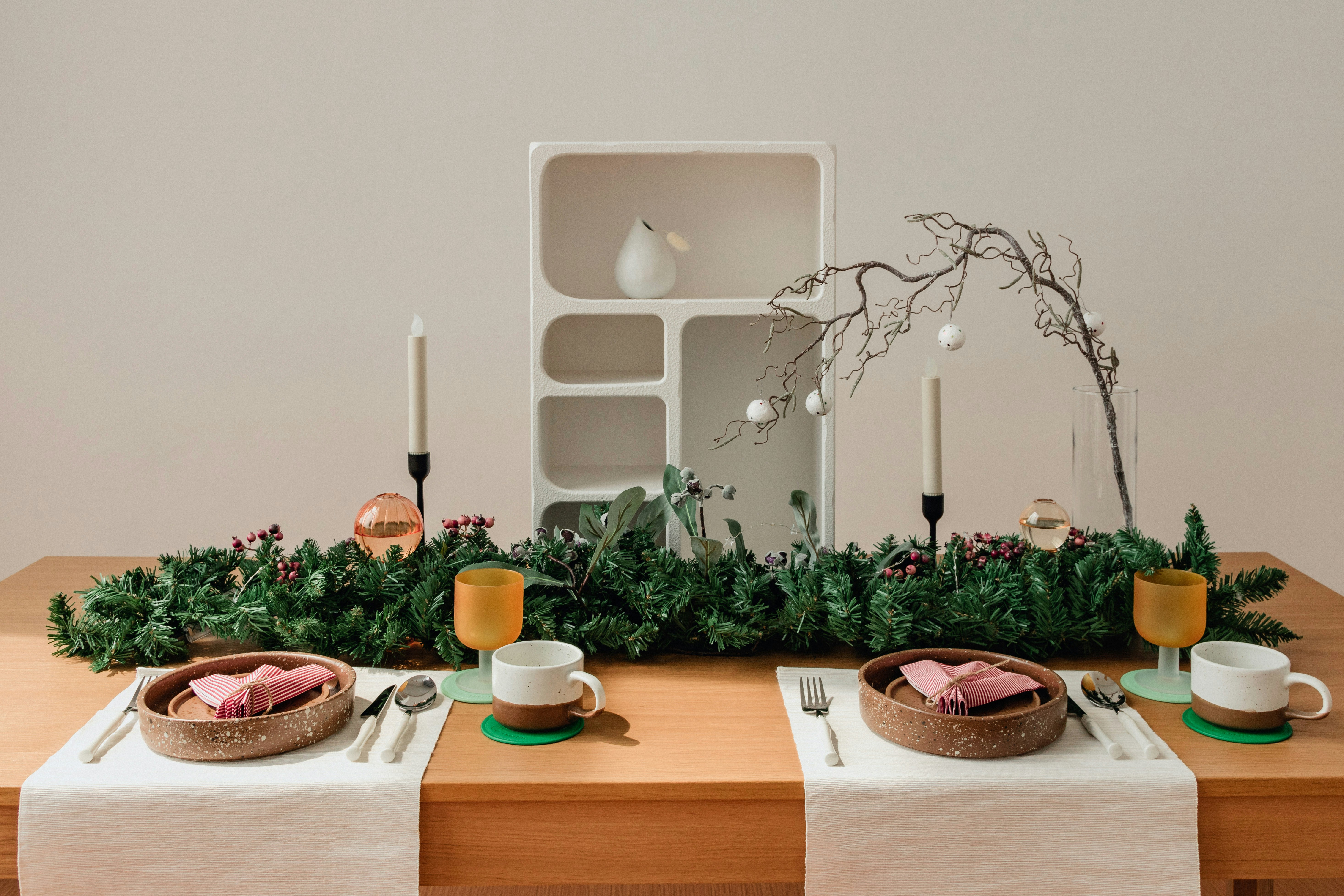 Wooden table with plates and bowls of food