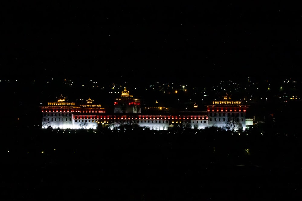 a large building lit up at night in the dark