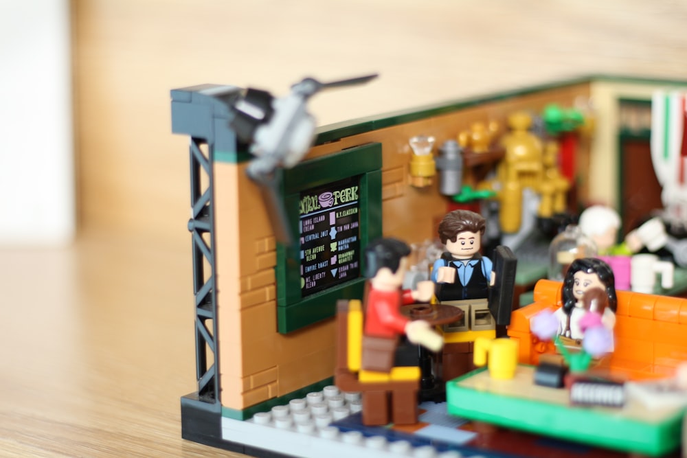 a lego model of a restaurant with people sitting at a table