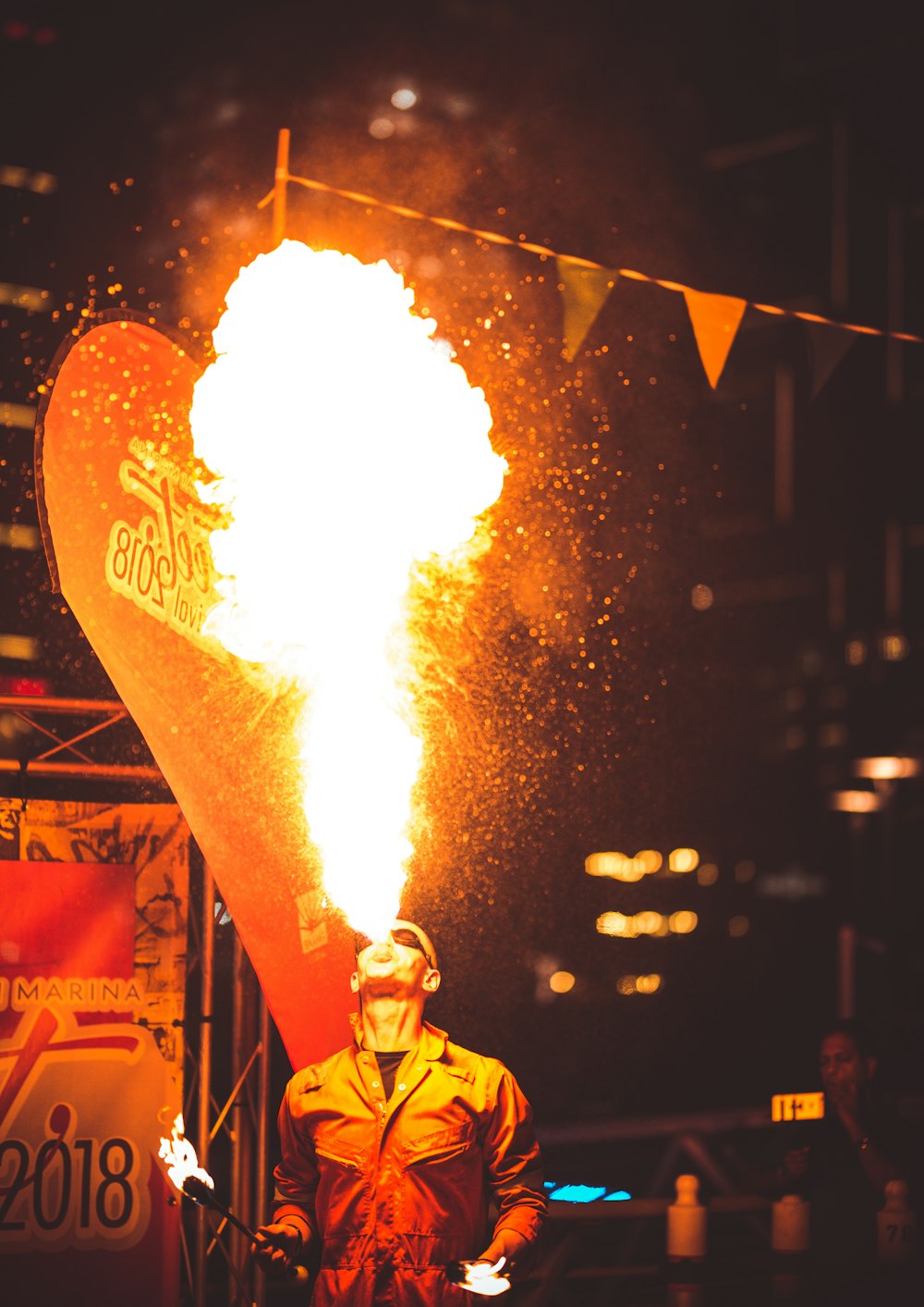 a man standing in front of a giant heart shaped balloon