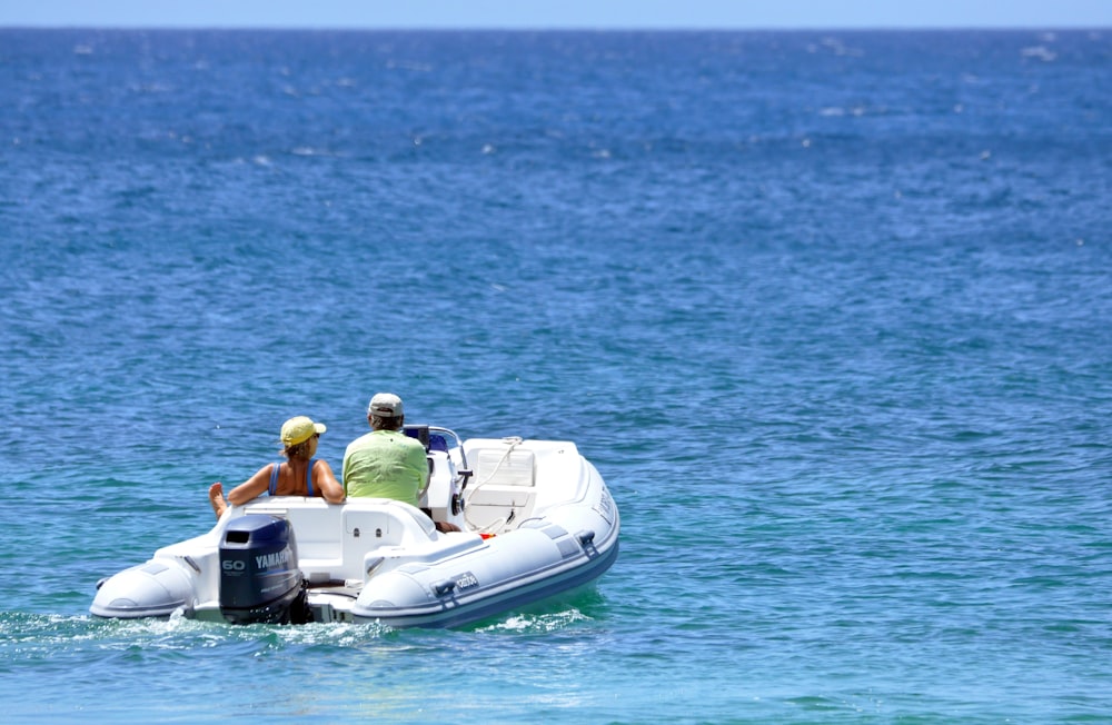 a couple of people riding on the back of a boat