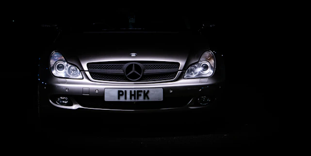 Sleek black luxury car silhouette with gold accents on a dark background, embodying premium automotive trade.